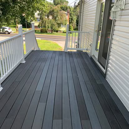 A clean front porch with dark grey composite decking.